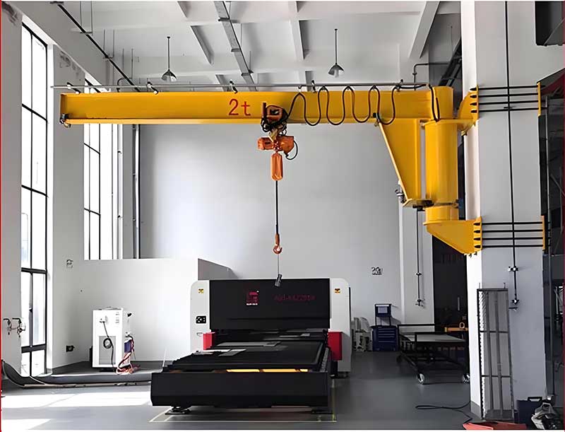 Wall jib serving a work cell with chain hoist
